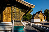 Wat Xieng Thong temple in Luang Prabang, Laos.  A view of the 'sim' with the pointed arch chapel and the Hall of the Royal Funerary carriage in the distance. 